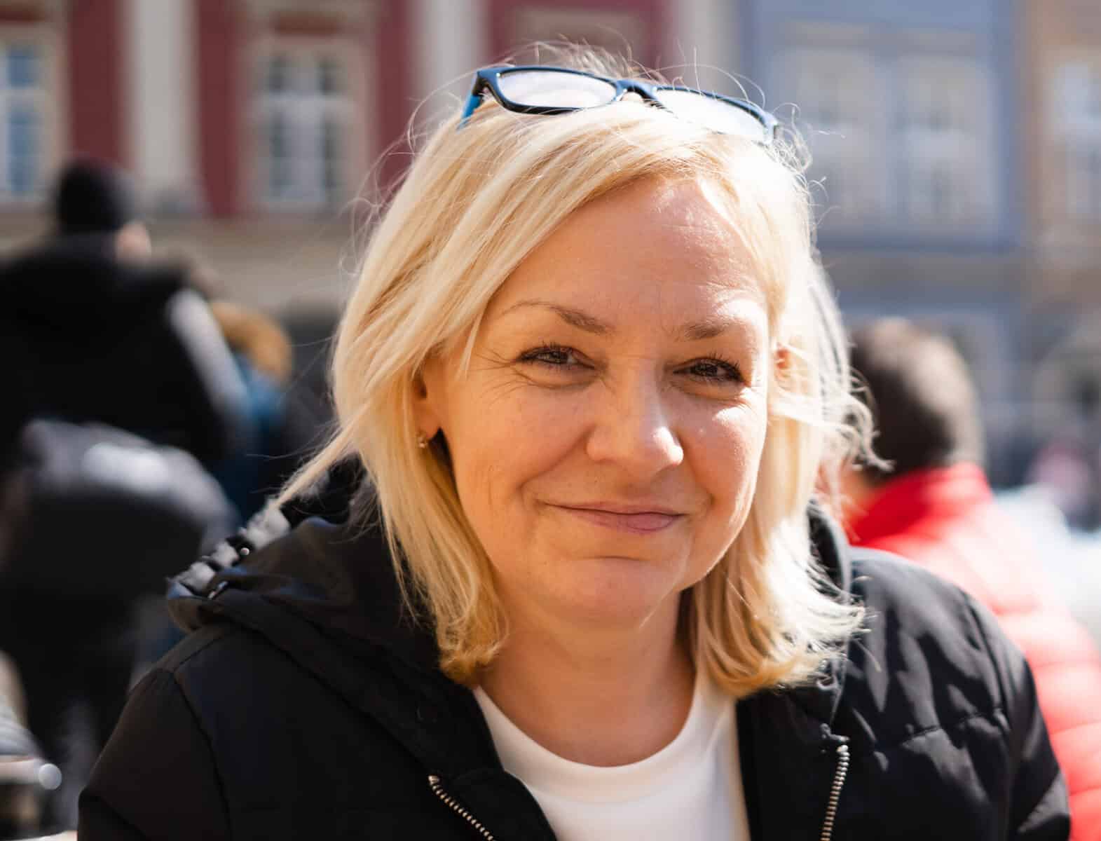 Mature 50s caucasian woman with blond hair outdoors on sunny day. European travel